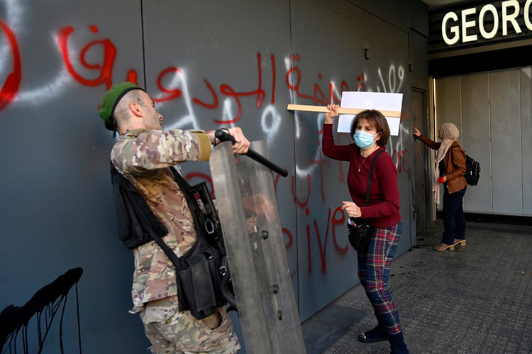 درگیری یک مشتری معترض با یک سرباز در جریان اعتراض در مقابل شعبه فرانس بانک. بیروت، لبنان