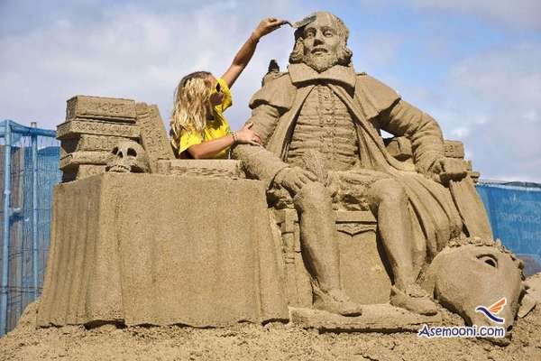 Sand sculptor and artist Nicola Wood, aged 27, from Leicester, England, works on her sculpture of William Shakespear Monday July 26, 2010, in the Weston-super-Mare Sand Sculpture Festival on the beach, which this year has the theme and celebration of all things British. The exhibition is a popular annual event at the  south western England seaside resort where the sand is perfect for world-class sand sculpture. (AP Photo/PA, Ben Birchall) ** UNITED KINGDOM OUT NO SALES NO ARCHIVE **