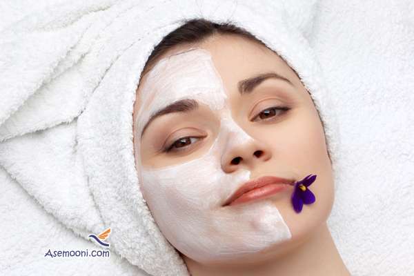 young pretty woman getting facial mask, lot of copyspace