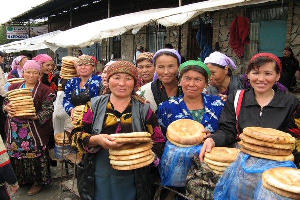 Uzbek women selling bread in Urgut Sunday market, Uzbekistan