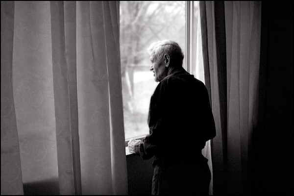 My grandfather, Charles Crawford, looking out the window of his house.