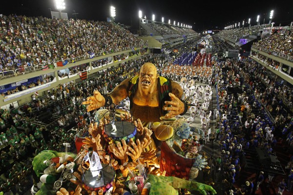 Dancers of Grande Rio samba school parade on a float during carnival celebrations at the Sambadrome in Rio de Janeiro, Brazil, Tuesday, Feb. 21, 2012.  Nearly 100,000 paying spectators turn out for the all-night spectacle at the Sambadrome. (AP Photo/Victor R. Caivano)