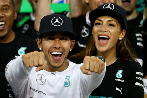 ABU DHABI, UNITED ARAB EMIRATES - NOVEMBER 23:  Lewis Hamilton of Great Britain and Mercedes GP celebrates with his team and Nicole Scherzinger after winning the World Championship after the Abu Dhabi Formula One Grand Prix at Yas Marina Circuit on November 23, 2014 in Abu Dhabi, United Arab Emirates.  (Photo by Clive Rose/Getty Images)