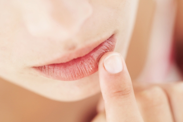 close-up of a woman applying lip balm