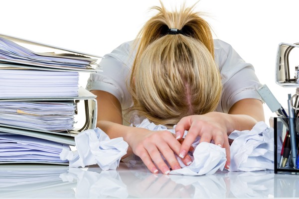 young woman in office is overwhelmed with work. burnout in work or study.