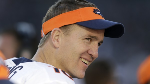 Denver Broncos quarterback Peyton Manning smiles while standing on the sideline during the second half of an NFL football game against the Oakland Raiders, Sunday, Dec. 29, 2013, in Oakland, Calif. (AP Photo/Marcio Jose Sanchez)